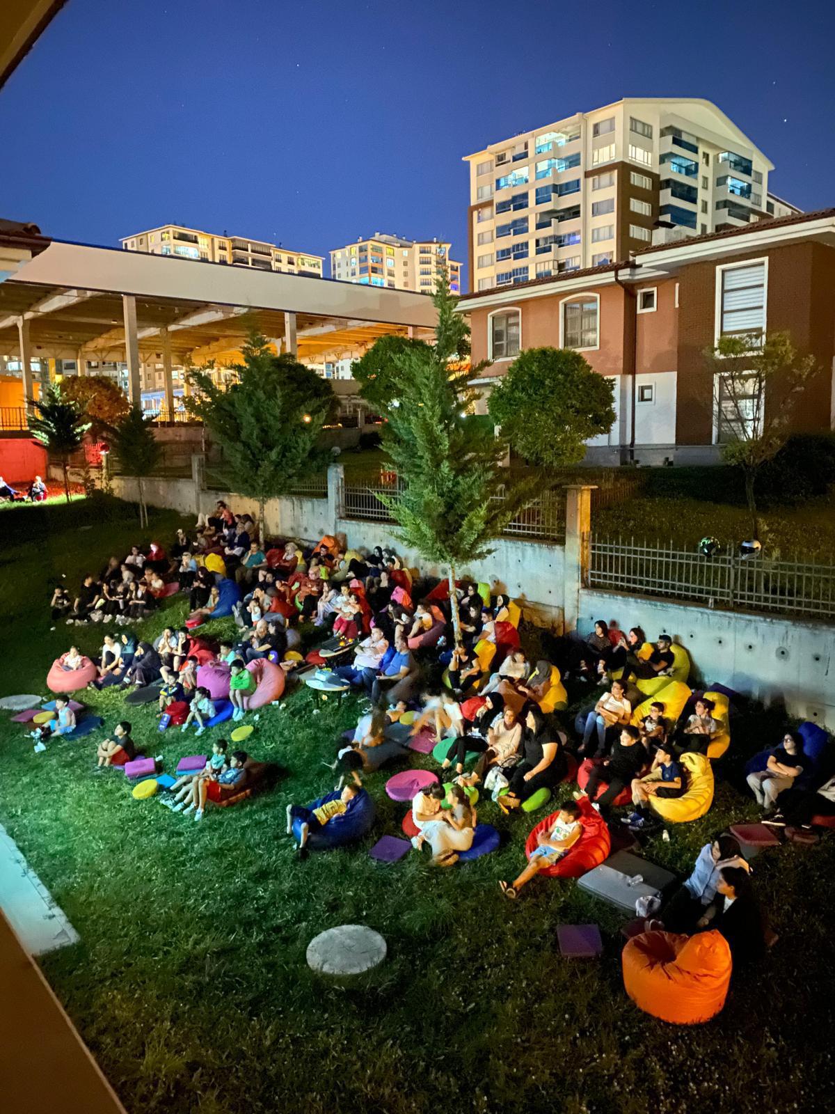 YOUNG PEOPLE MEET AT THE OPEN AIR CINEMA